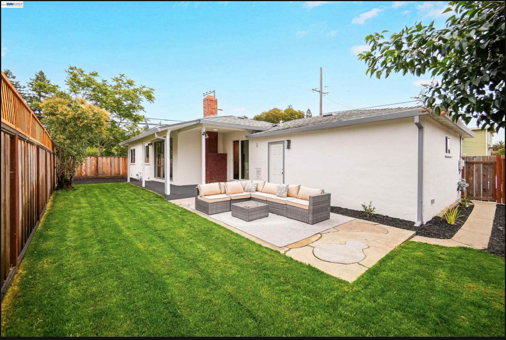 Backyard with covered patio and lawn
